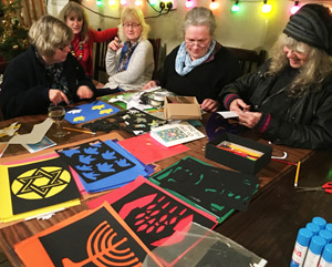 Paper-cutting at SCoJeC's Chanukah party in Dumfries